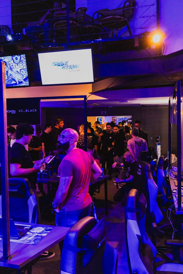 Home A bustling gaming expo showcasing technology with people engaged at gaming stations.