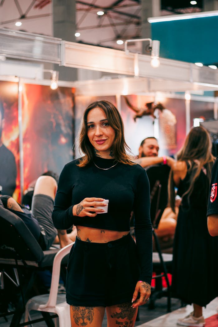 Home Smiling woman with tattoos enjoying a dynamic expo. Perfect for lifestyle and events imagery.