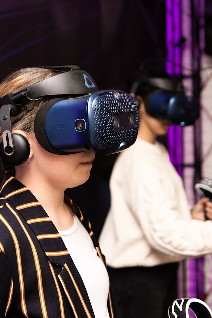 Services Two adults using VR headsets for an immersive experience indoors.